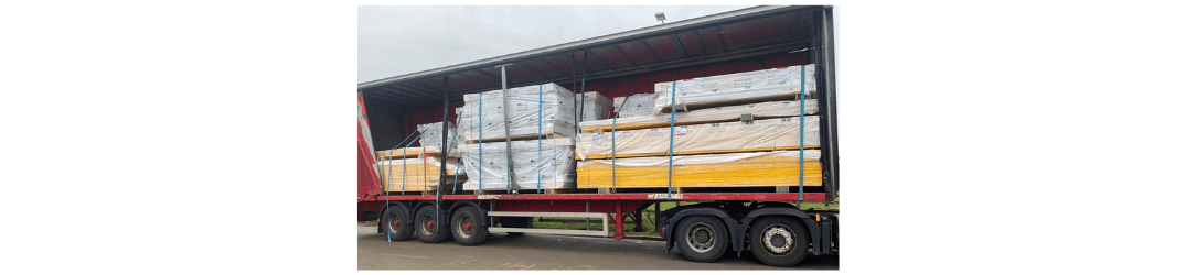 A lorry full with a full sips house kit and panels leaving the factory