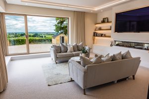 nergy-efficient SIPs house with large glazing and Cotswold stone façade